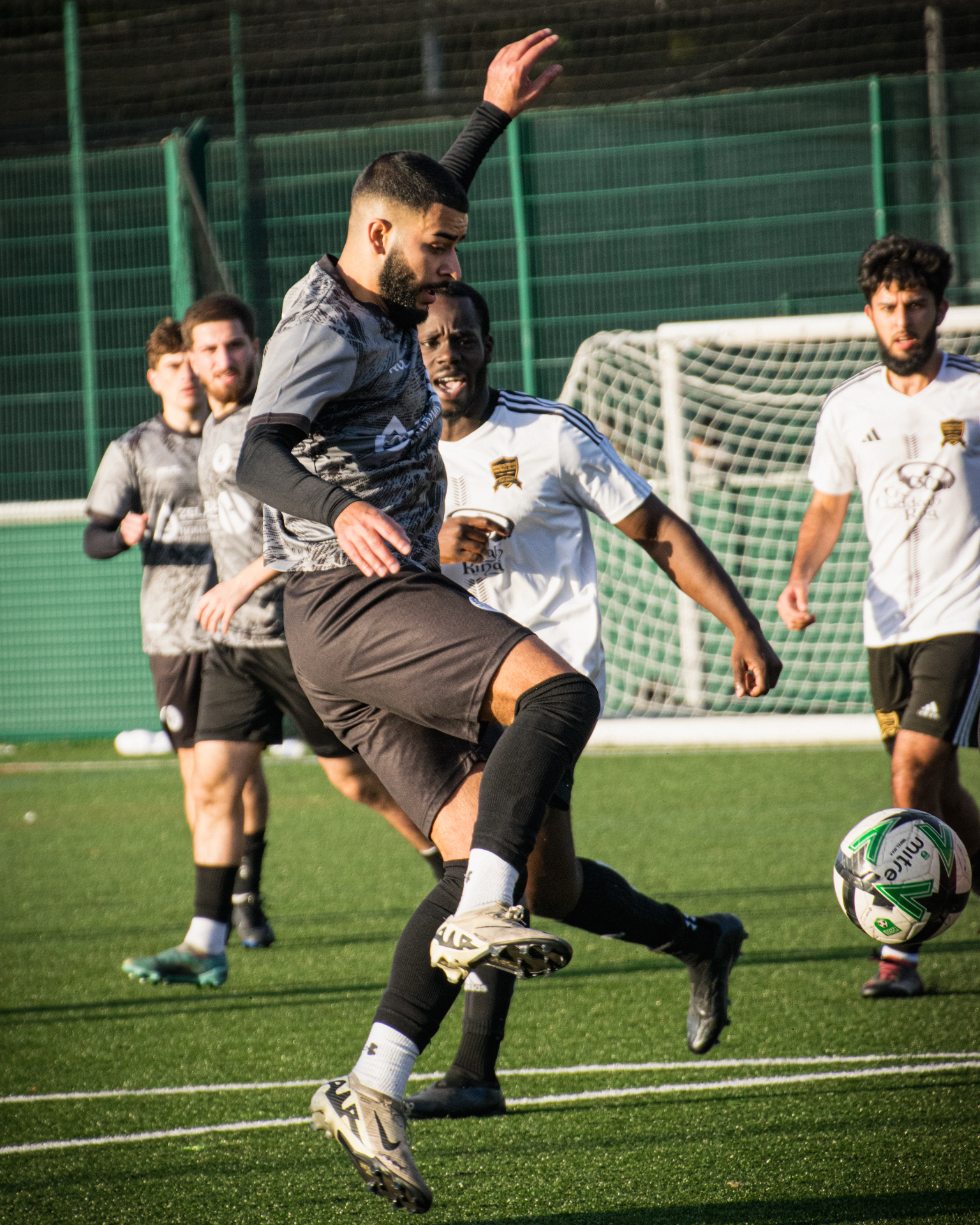 Forward shielding the ball under pressure