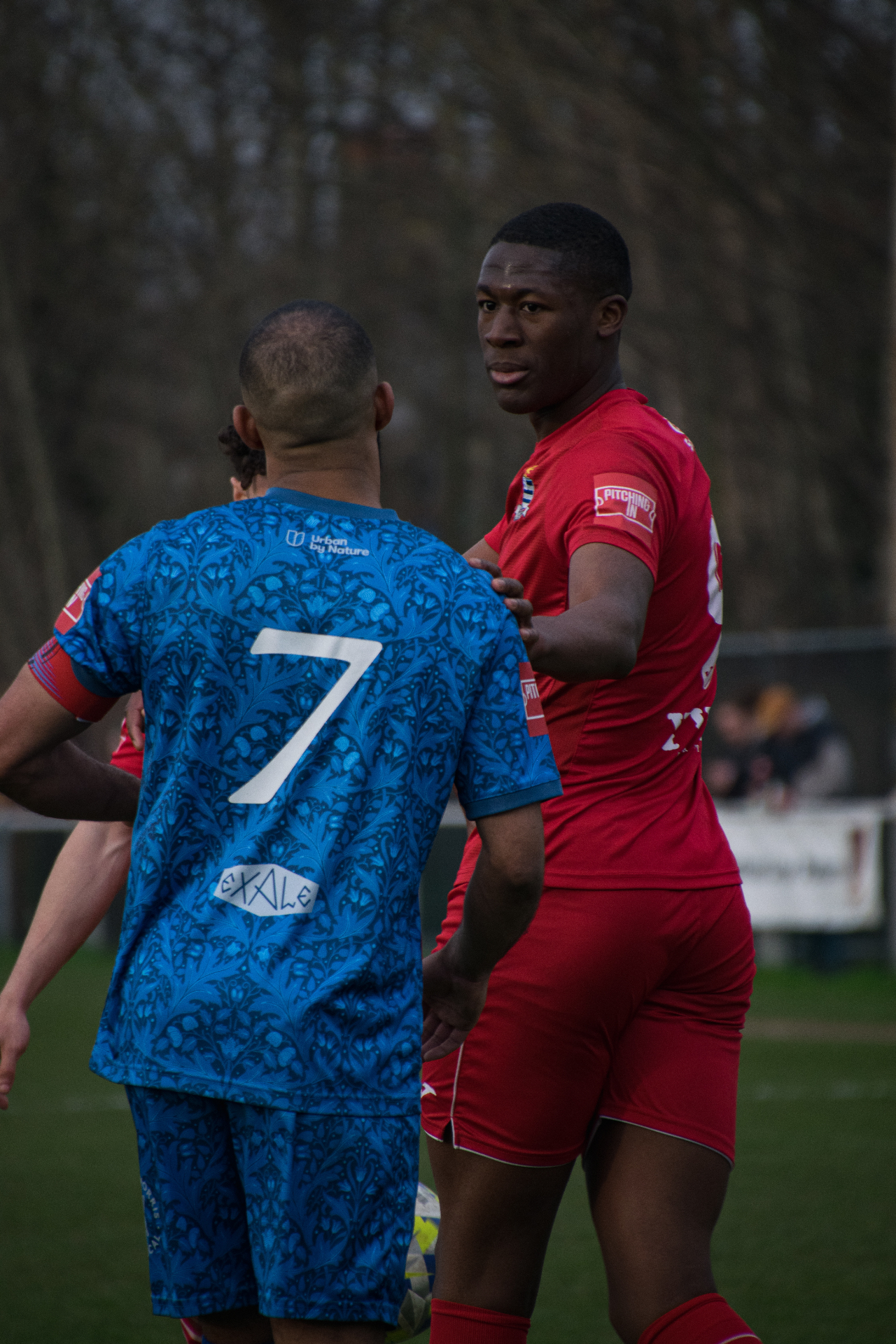 Football match moment, red and blue kits